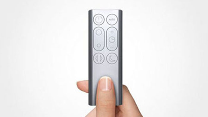 A tiny remote pinched by two fingers