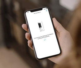 An iPhone held in a hand, with screen showing interface of setting the camera