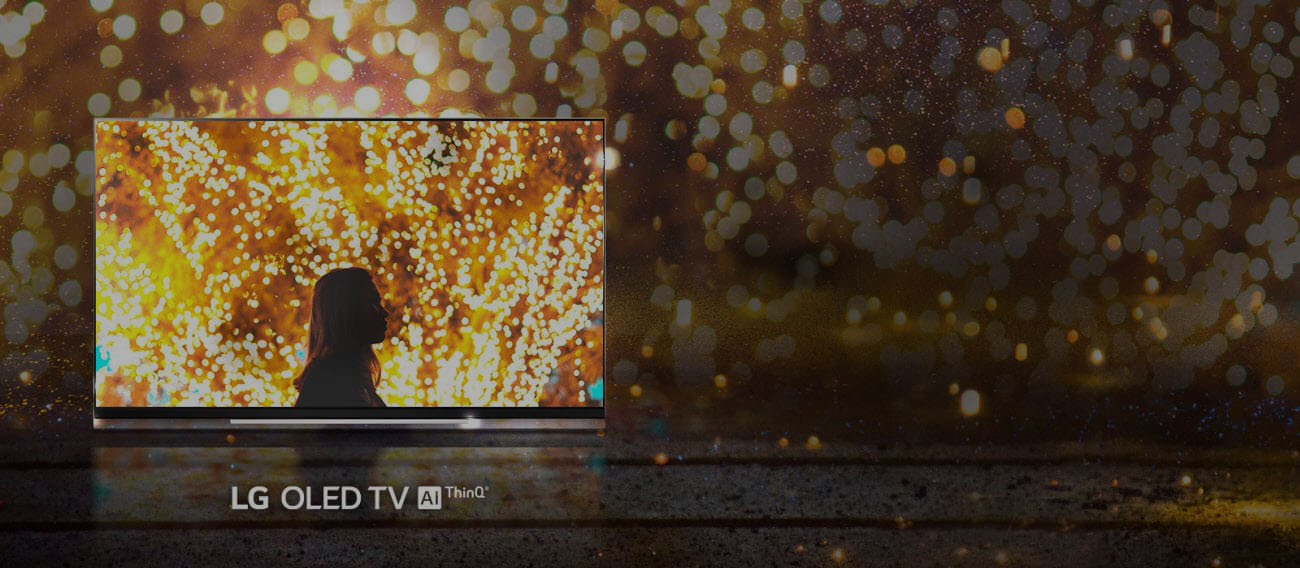LG E9 Glass Smart OLED TV showing a woman in a firework background