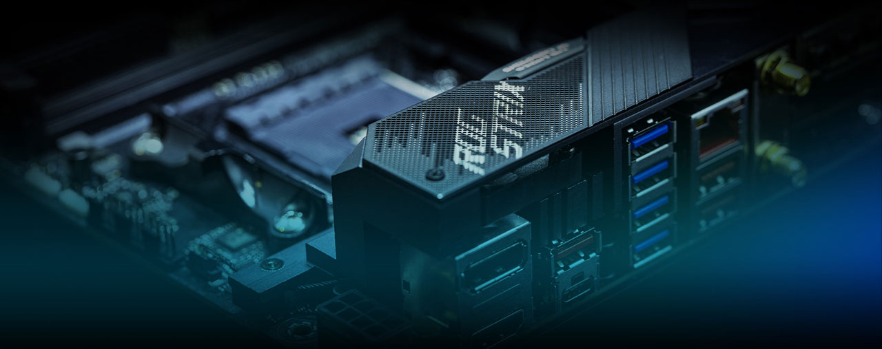 Closeup of the rear I/O panel, with blurred background of CPU socket on the motherboard