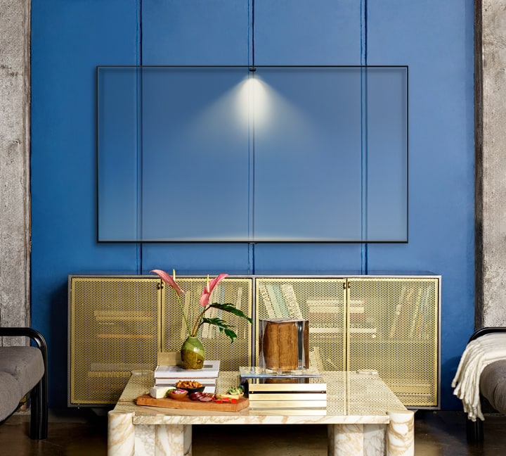 mounted Samsung Q80R blended in with the blue wall it's mounted on