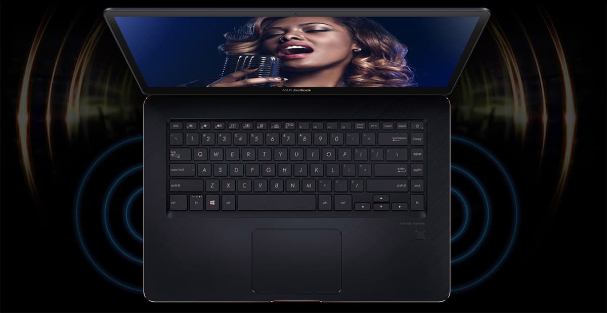 Overhead view of the ASUS ZenBook Pro 15 UX550GE open witha female singer singing into a microphone on-screen