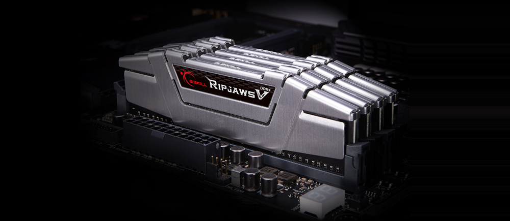 Quad G.SKILL Ripjaws V RAMs in black heat spreader on display, inserted into DIMM slots of a motherboard