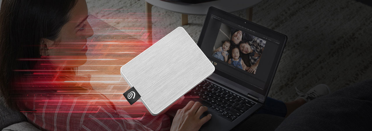Illustration showing the One Touch portable SSD moving at blazing fast speed, with background of a female watching a family photo on a laptop