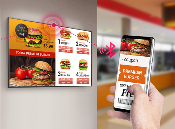Mirrored burger restaurant ad from a smartphone being displayed onto a mounted LG commercial display. The phone shows a coupon that is being connected to the display via Bluetooth