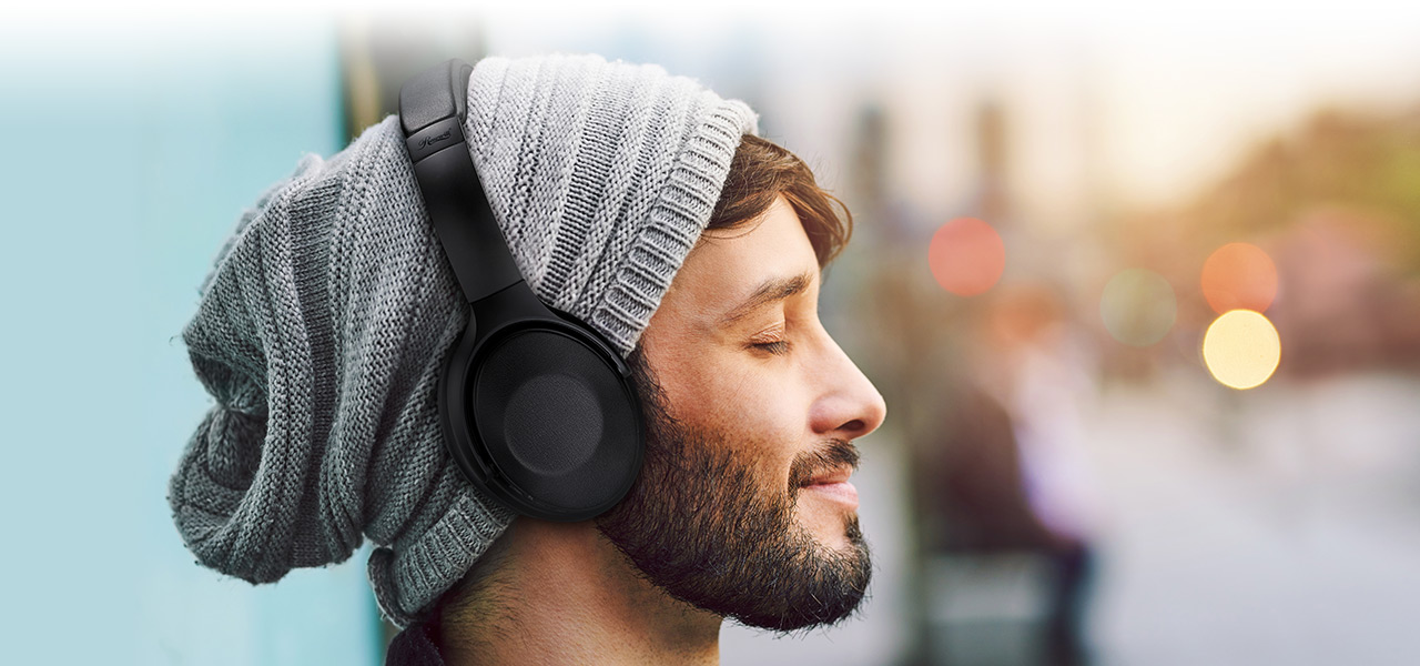 A man who is using the H9000 ANC Wireless Bluetooth Headphones and seems very enjoy it