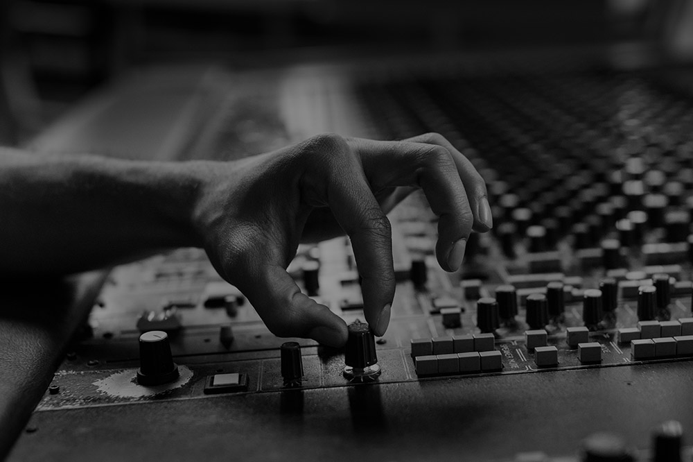 a producer tweaking a studio-console knob