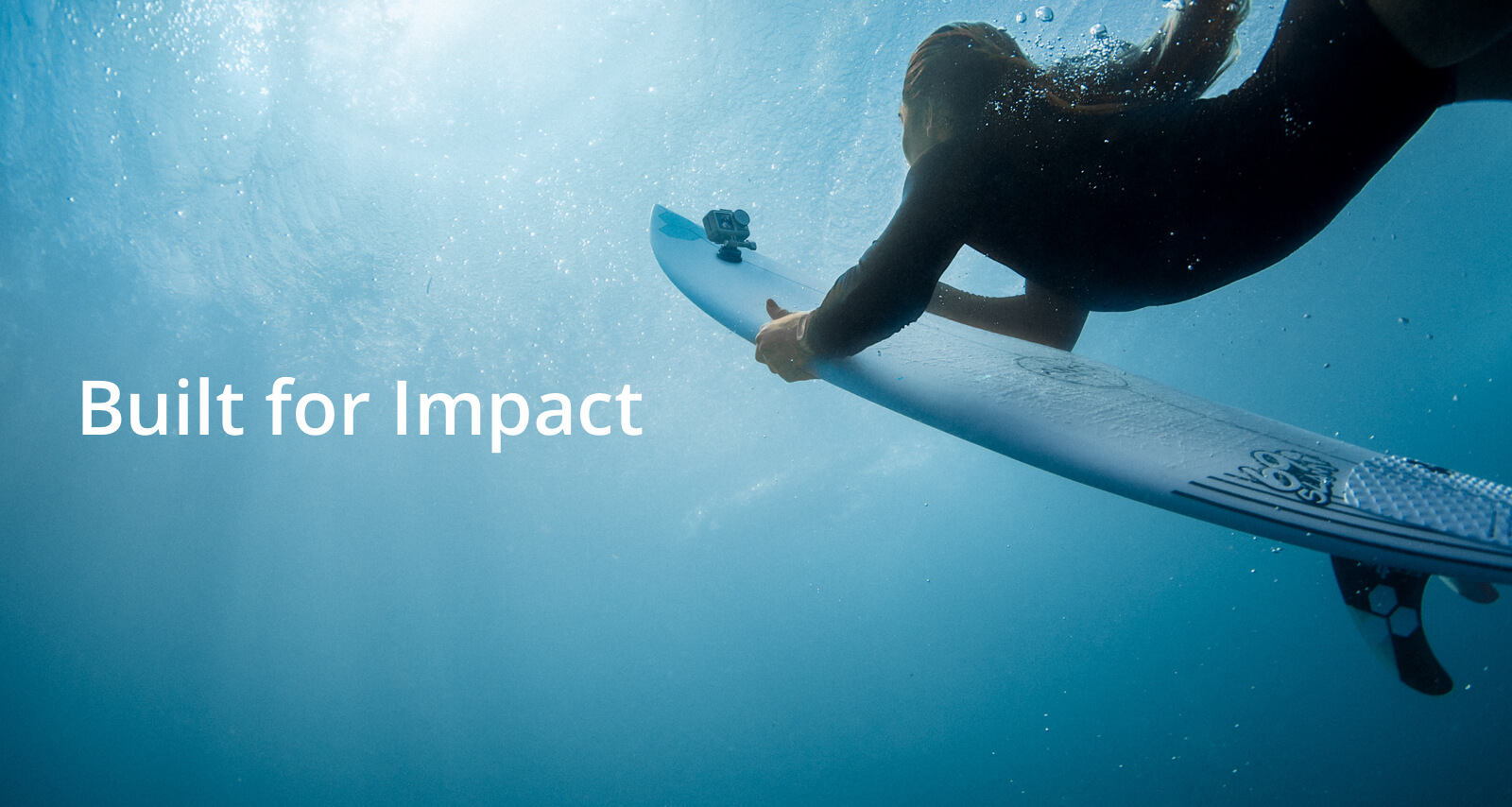 A female surfer under water with her surfboard that has an attached Osmo Action. In front is text that reads: Built for Impact