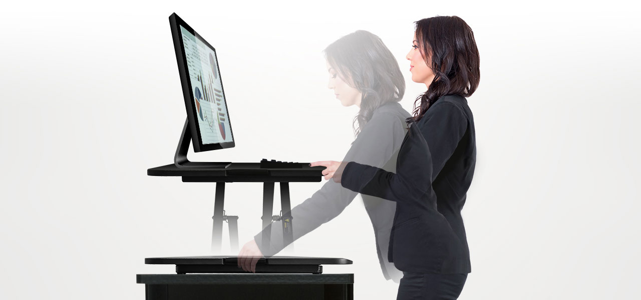 A lady who is using the Adjustable Standing Desk Riser Monitor Stand to improve she can adjust to comfort levels