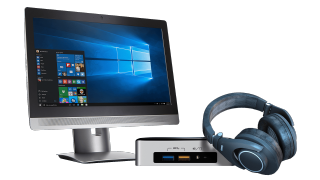 a monitor beside an Intel NUC and a headset