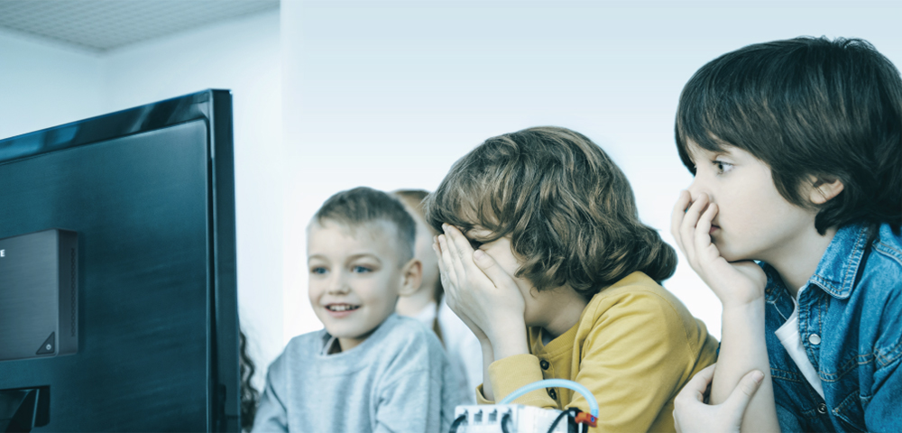 some children are in front of computer