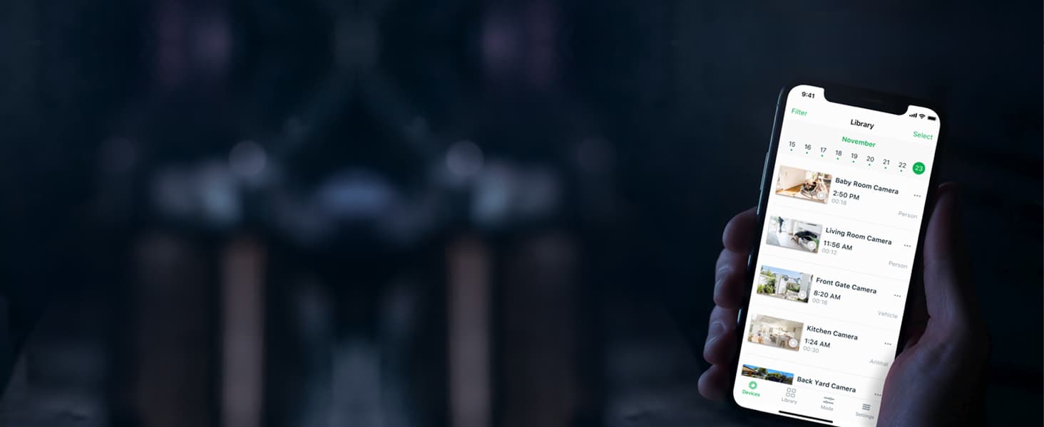 A hand holding up a smartphone with a library of videos open