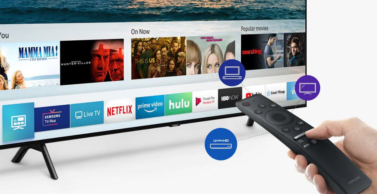 A hand using the Samsung Q70R OneRemote to navigate apps on the Samsung Q70R display