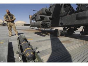 An AGM-114 Hellfire missile is ready to be loaded onto an AH-64 Apache Poster Print (34 x 22) An AGM-114 Hellfire missile is ready to be loaded onto an AH-64 Apache Poster Print (34 x 22)