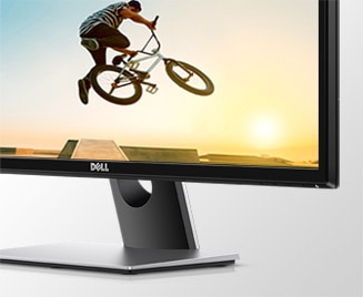 Dell monitor angled to the left with a BMX biker doing a trick mid-air