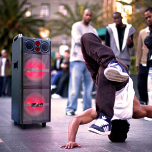 BeFree Sound BFS-5501 Party Speaker on a street floor during the day with a man breakdancing in front of it