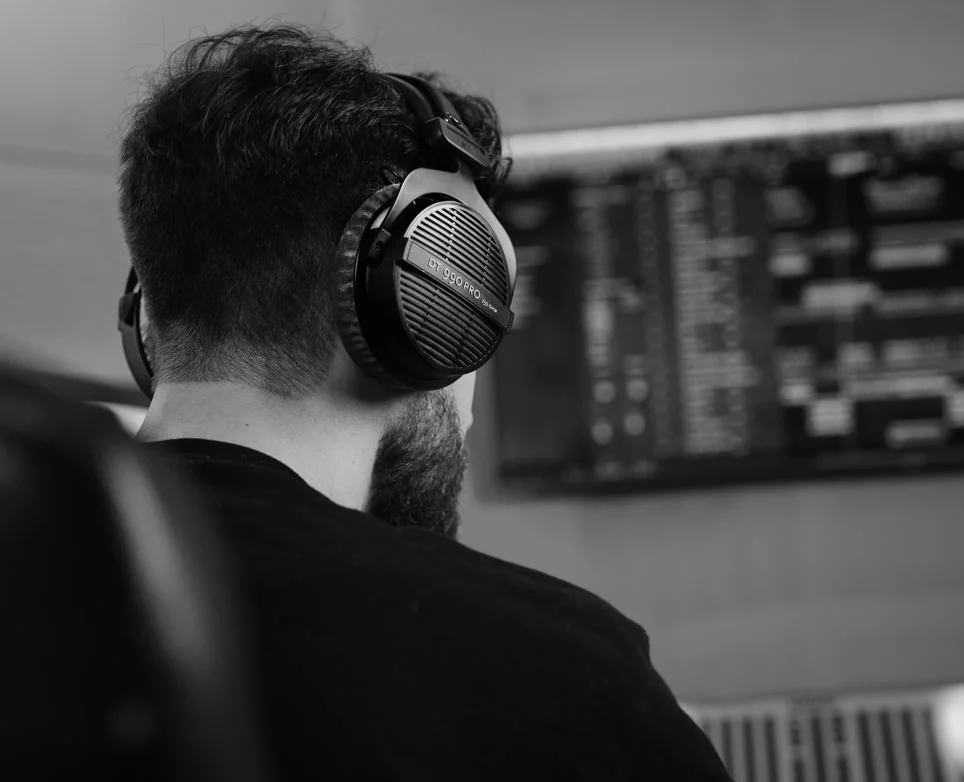 A man wears Beyerdynamic DT 990 PRO Open Back Headphones