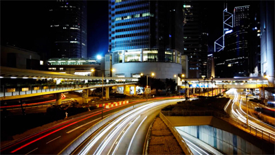 Action shot of a city and its highway with cars zooming by