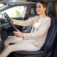 Demonstration of the cushion on a car seat . with a female sitting on the cushion