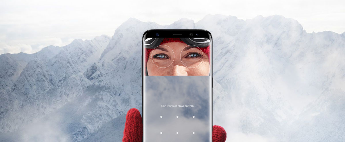 Security Lock Screen of the Samsung Galaxy S8 in a Red-Gloved Hand in Front of a Snow-Covered Mountain Range