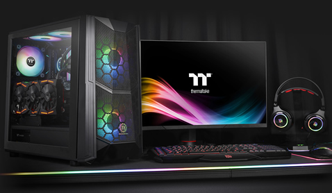 Thermaltake Commander C35 Case Fully Loaded with components next to a gaming monitor, keyboard, headphones and mouse