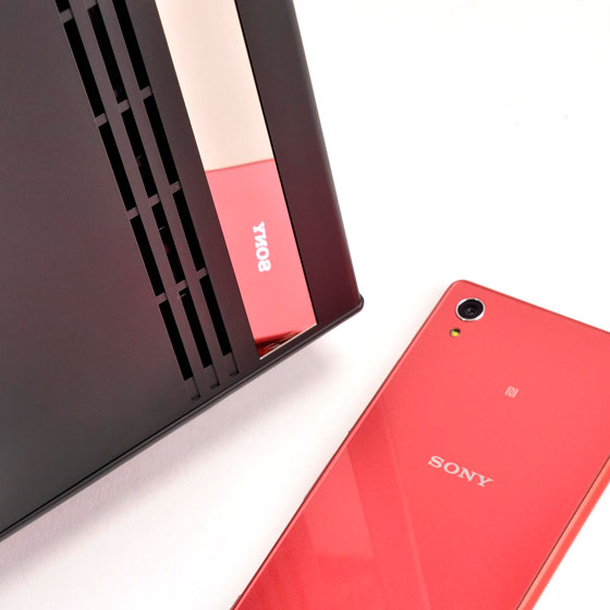 close look at the mirror-like trim and a pink Sony Xperia phone