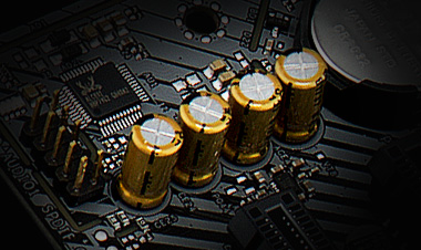 Closeup of the gold-plated audio caps on the ASRock b450 motherboard