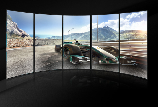 The scene of a race car raging on the track is diplayed on a five-display screen.