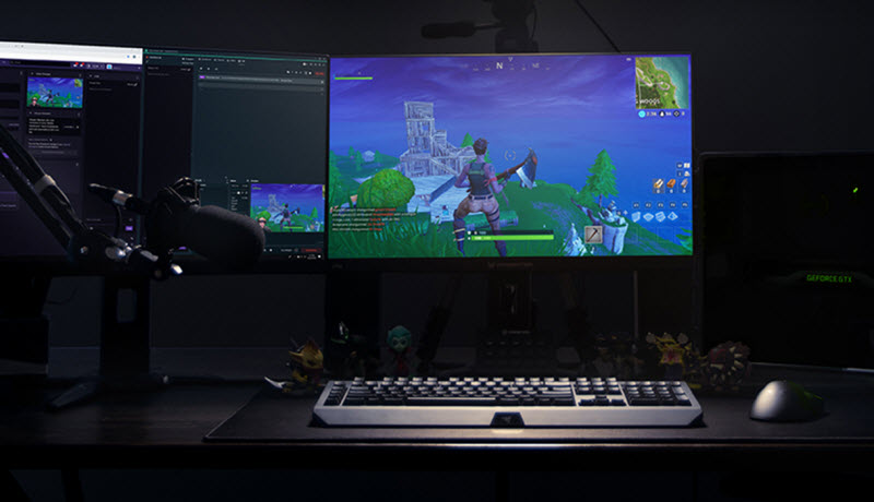 a dual-monitor setup is broadcasting Fortnite