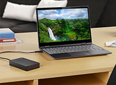 black Backup Plus Portable connects to a laptop