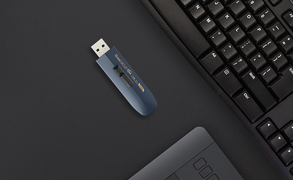 TeamGroup c188 flash drive on a desk next to a desktop keyboard