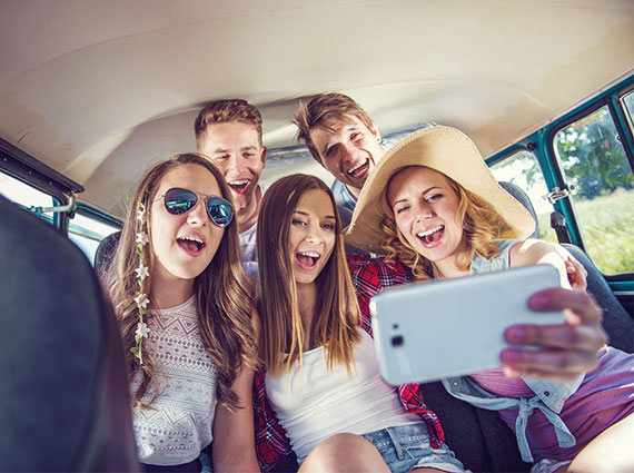 A Group of Friends Taking a Selfie Inside a VW Bus
