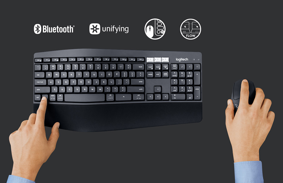 A hand touching the function key on the Logitech MK850 Performance Wireless Keyboard along with the Bluetooth, unifying, mouse + keyboard icon and computer to computer flow