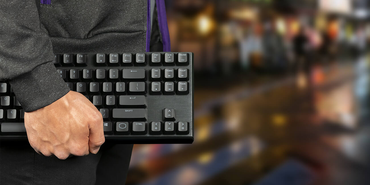 Closeup of a man carrying the MK730 keyboard by his side