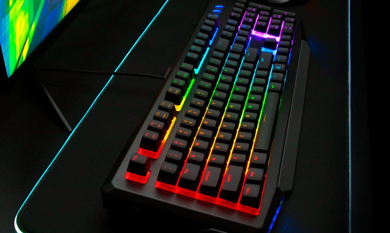 Rosewill NEON K42 placed beside a monitor with its RGB lit up