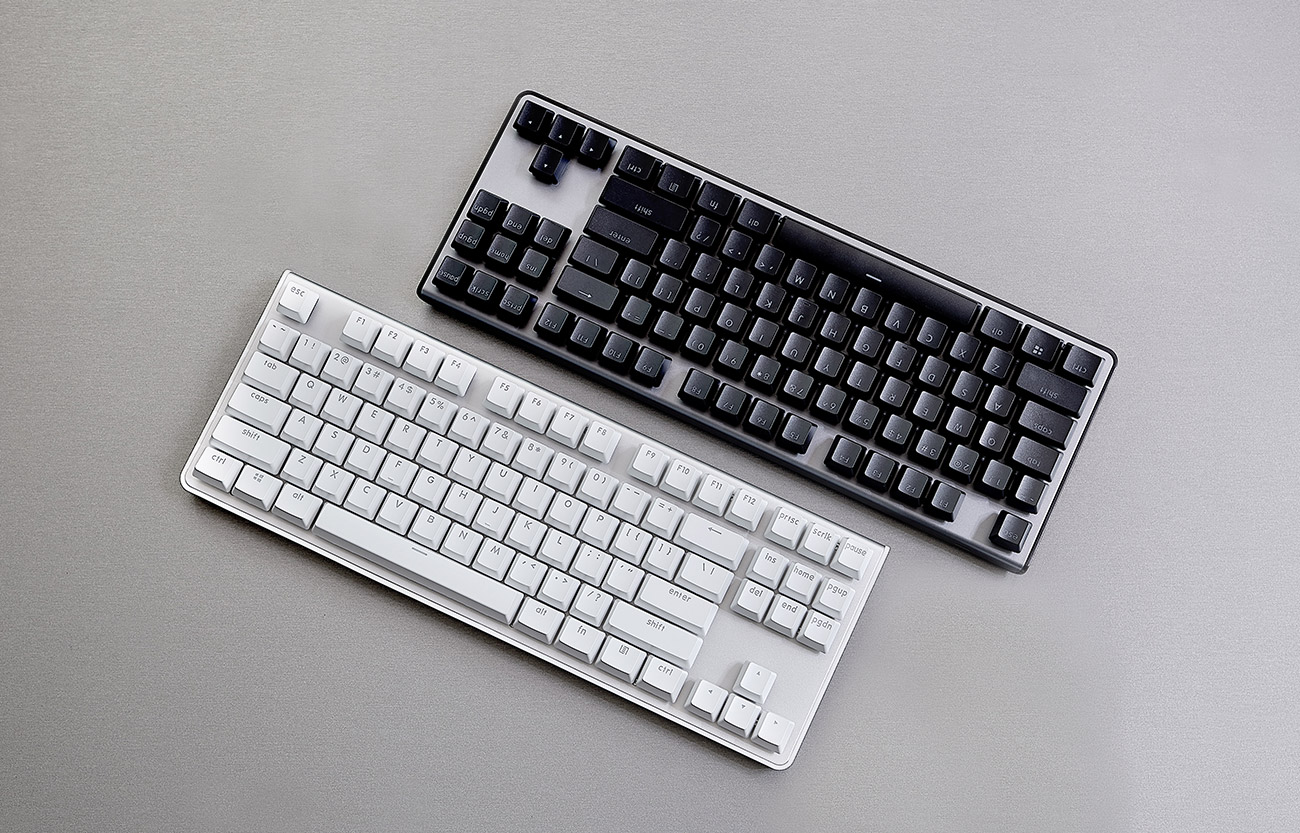 a black keyboard and a white keyboard