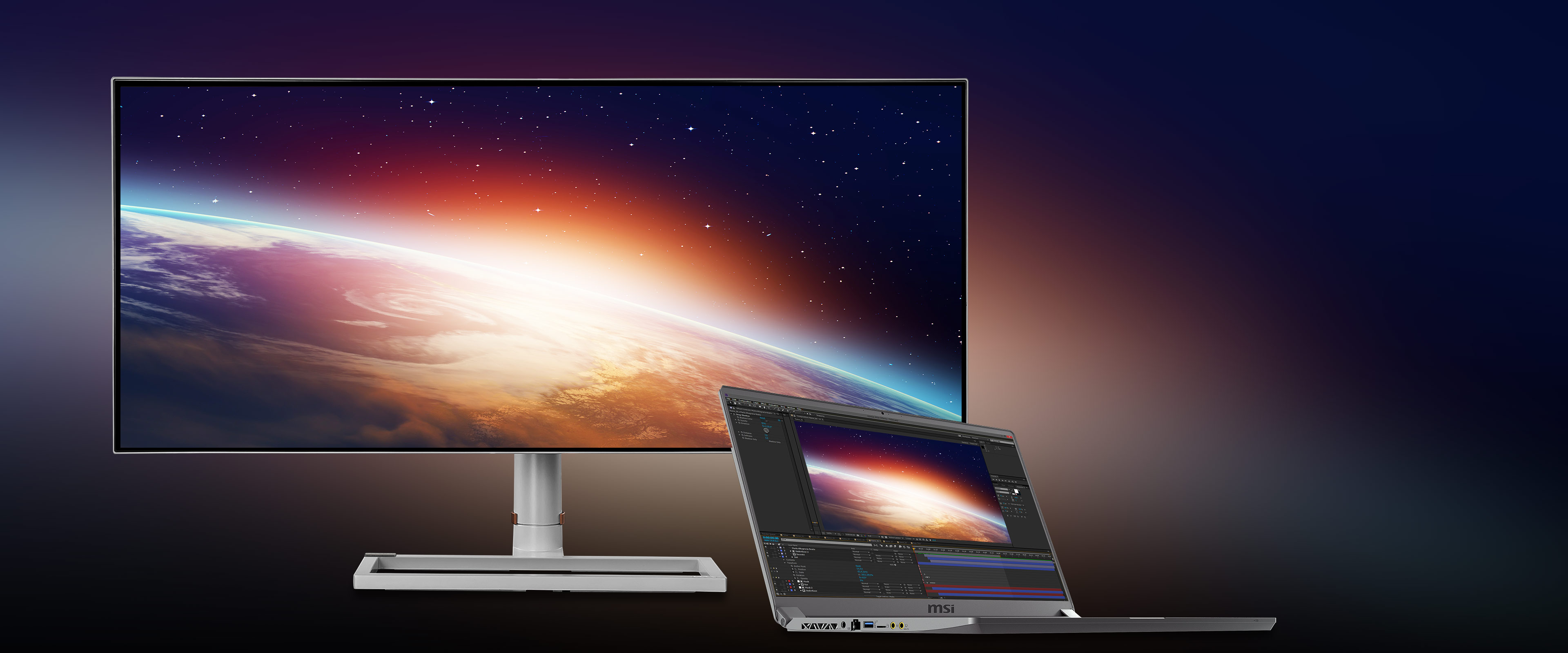 a monitor and a laptop with a space image as screen