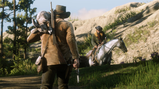 screenshot3 for Red Dead Redemption 2 showing a man with a dead deer on his left shoulder met another man