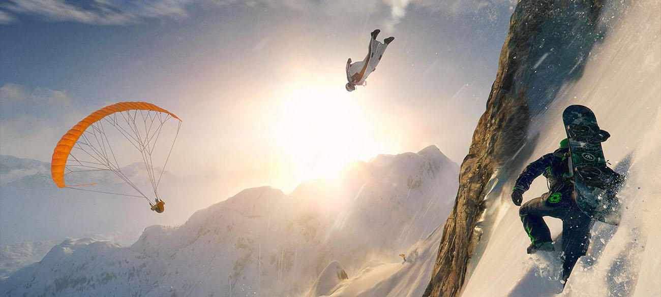 A snowboarder walking across a steep snow-covered mountain side while another player is flying down in a wingsuit