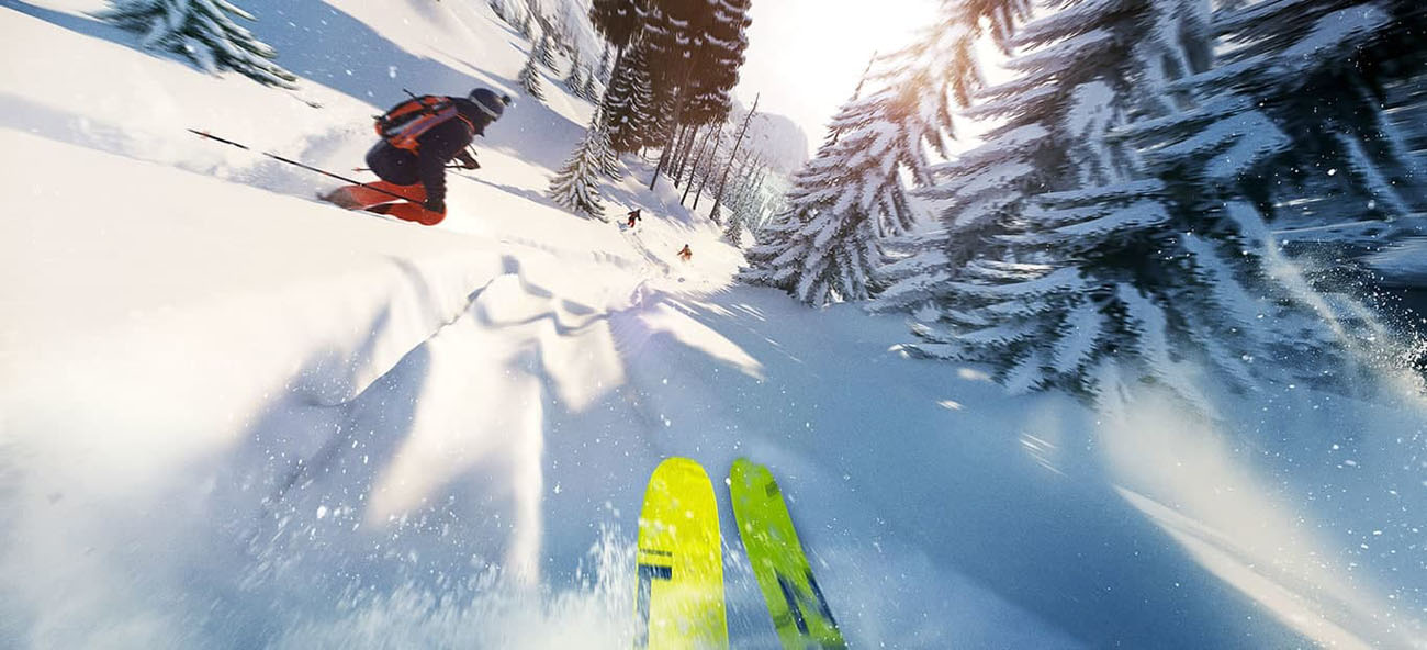 1st person view of a skier going down a snowy mountain through snow covered evergreen trees