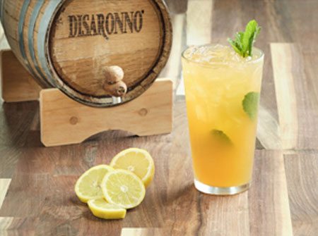 a Maggiano drink next to a small alcohol cask
