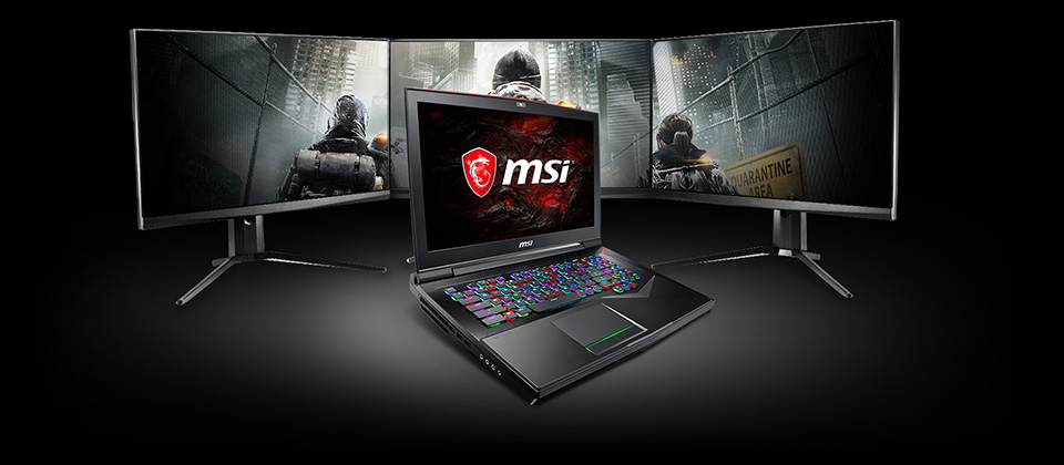 Gigabyte GT75 TITAN Gaming Laptop open, angled to the left in front of three connected monitors showing a screenshot from Ubisoft's The Division