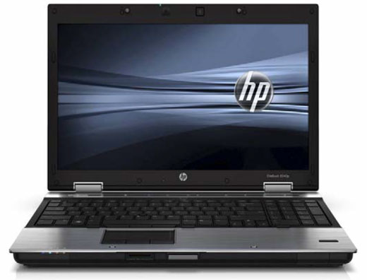 HP EliteBook 8540P laptop, open and facing forward with a black and gray graphic background with the HP logo
