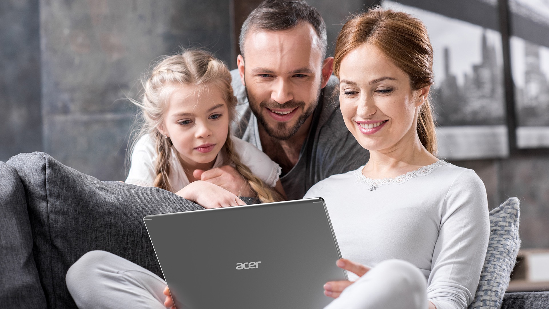 Family are watching Acer Aspire Notebook with smiles.