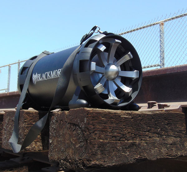 The Blackmore BTU-5008-B Speaker Outdoors on the wood of a railroad track next to a chain-link fence