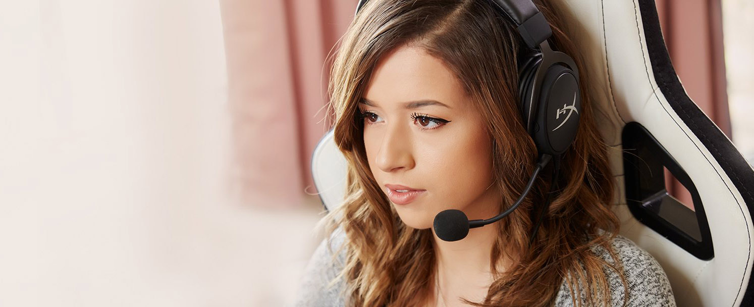 Pokimane with the HyperX headset and attached mic on, in her gaming chair looking to the left