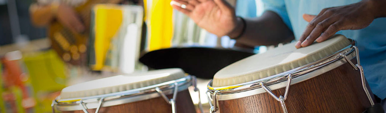 People are patting on a drum