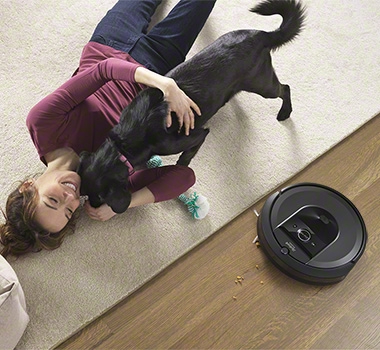 iRobot Roomba i7+ is cleaning next to a carpet