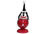 10.5 Playful Glittered Black and White Penquin Laying on Large Red Jingle Bell Christmas Table Top Decoration