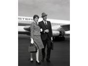 Mature couple at airport Poster Print 24 x 36